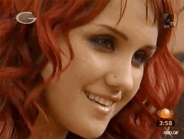 a close up of a woman 's face with the time of 3:58 on the bottom