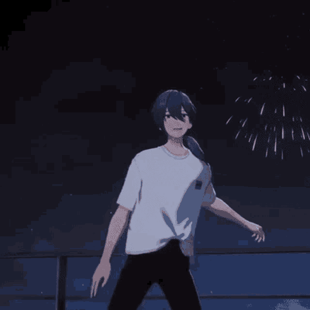 a man in a white shirt is standing in front of a fireworks display at night .