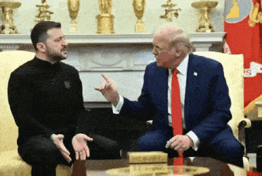 two men are sitting on a couch and one of them is wearing a shirt that says ' ukraine '
