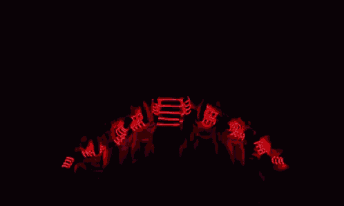 a group of people wearing glow in the dark shirts are dancing