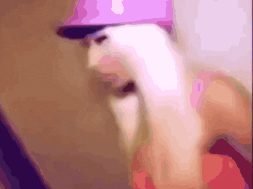 a blurry image of a person wearing a pink hat