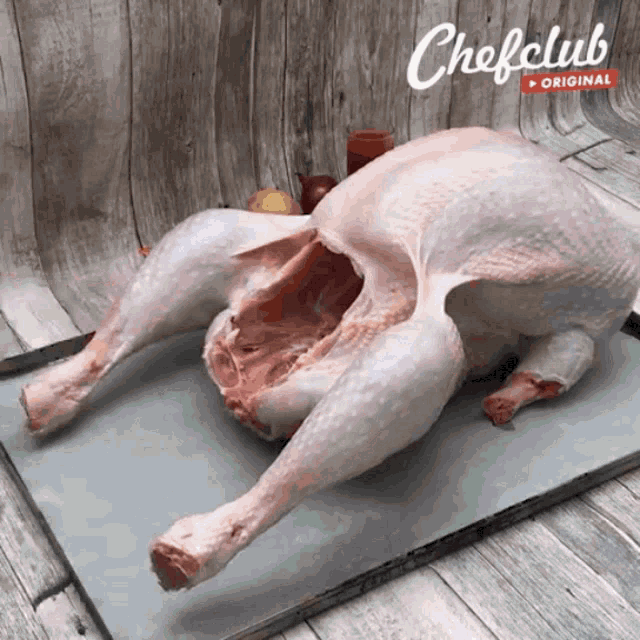 a turkey is laying on a cutting board with chefclub original written on the bottom