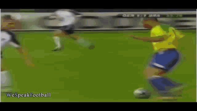 a soccer player in a yellow shirt is kicking a soccer ball