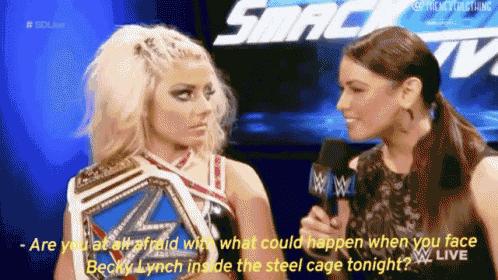 two women are talking to each other in front of a sign that says smack tv