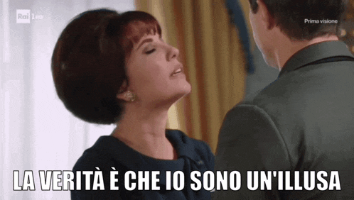 a man and a woman are looking at each other and the woman says la verita e che io sono un illusa