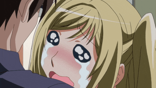a girl with a sad look on her face is being held by a boy