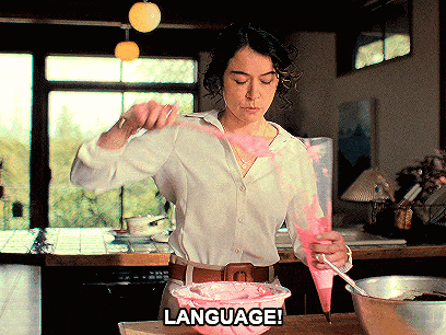 a woman in a white shirt is piping pink frosting into a bowl with the words language written below her