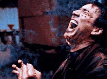 a man is smoking a cigarette with his mouth wide open