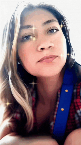 a close up of a woman 's face with sparkles in her eyes