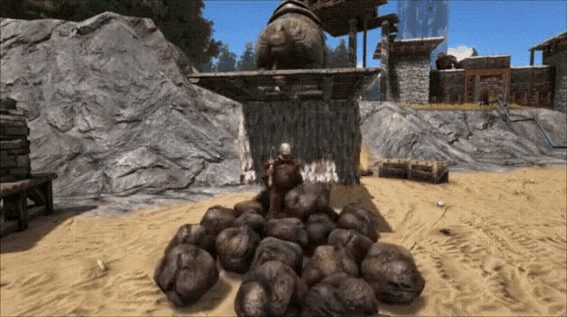 a video game scene with a pile of rocks in the sand