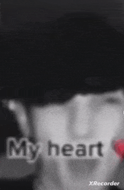 a close up of a person 's face with the words `` my heart '' written on it
