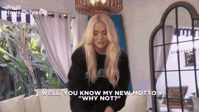 a woman says " well you know my new motto " in front of a mirror