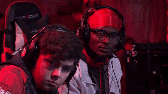 a man wearing headphones and a red headband with the letter s on it
