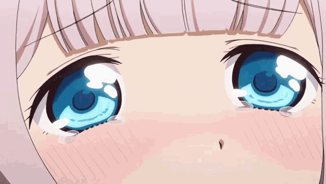a close up of a girl 's eyes with water coming out of them