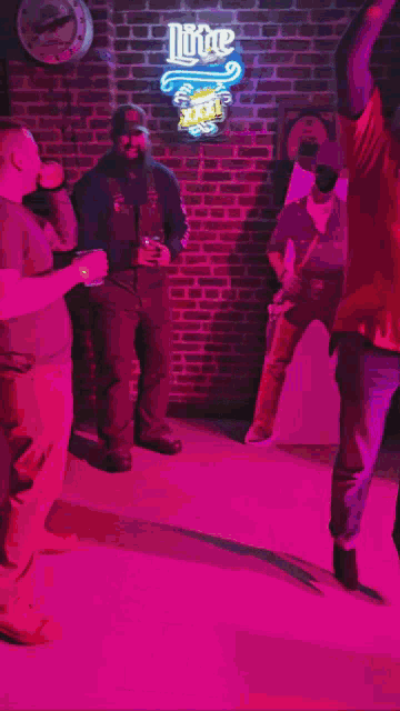 a man standing in front of a lite beer sign