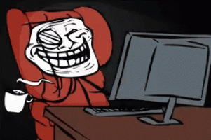 a troll is sitting in front of a computer and drinking a cup of coffee