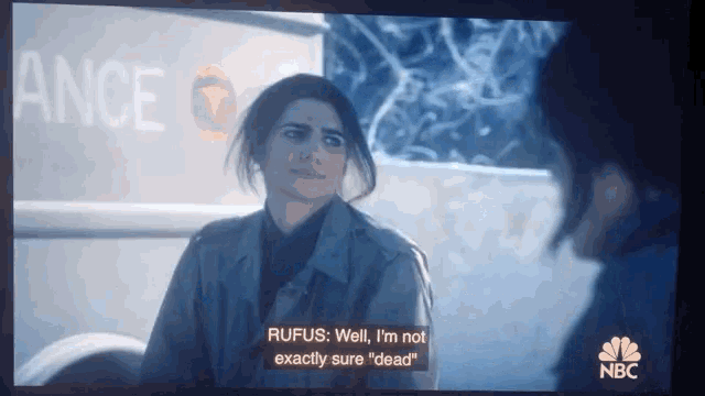 a nbc screen shows a woman talking to another woman in front of an ambulance