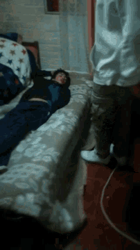a person laying on a bed with a blanket that says stars on it