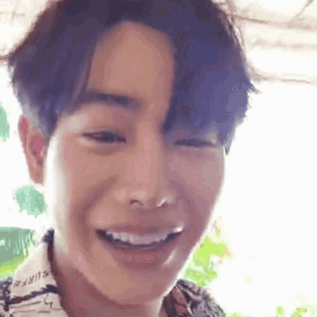 a close up of a man 's face with a smile on his face .