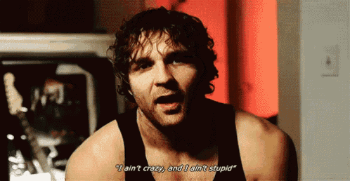 a man in a black tank top is saying " i ain t crazy and i ain t stupid "