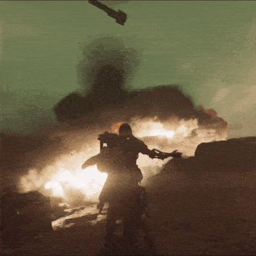 a man standing in front of a large explosion