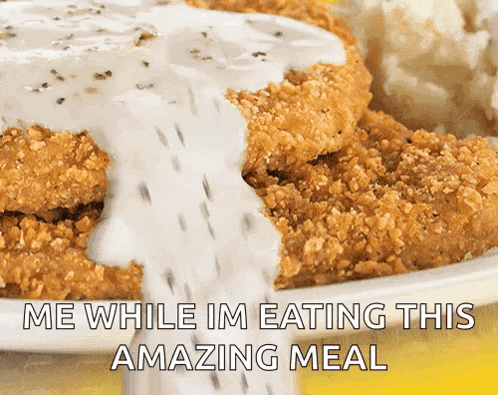 a plate of chicken fried steak with gravy and mashed potatoes