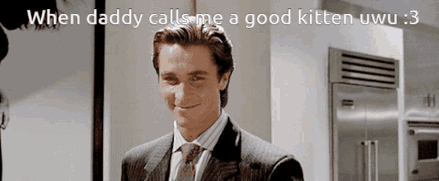a man in a suit and tie is smiling and says when daddy calls me a good kitten uwu 3