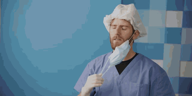 a surgeon wearing a surgical cap and a mask