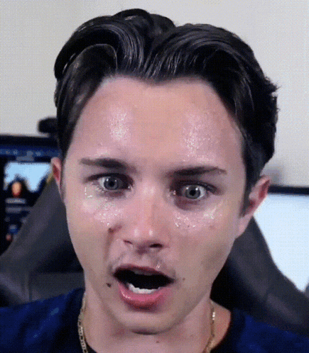 a close up of a man 's face with sweat on his forehead