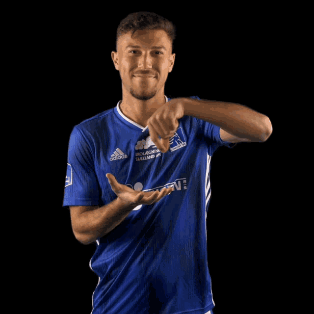 a man wearing a blue adidas shirt with jensen written on it