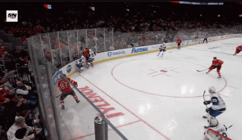 a hockey game is being played in a stadium with fastenal advertising on the boards