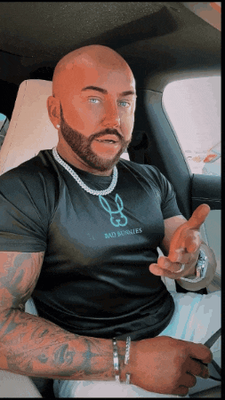a bald man with a beard is wearing a black shirt that says bad bunnies