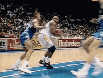 a basketball game is being played with a budweiser ad in the background