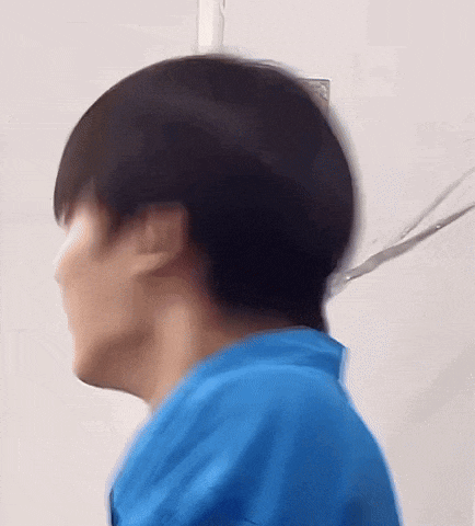 a close up of a person 's head and neck with a blue shirt on .