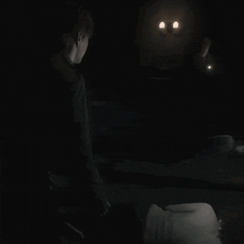 a man standing next to a woman laying on the floor