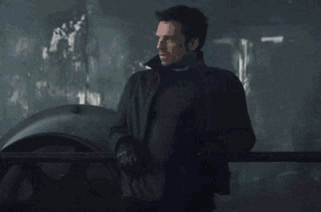 a group of men are walking in a dark room with a lot of windows