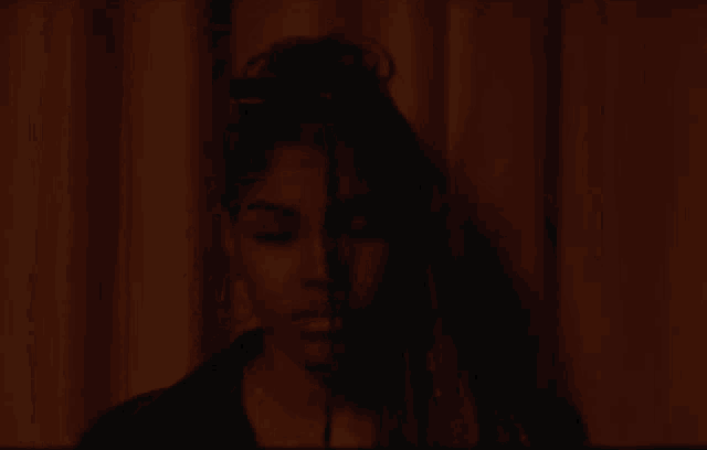 a close up of a woman 's face with half of her face obscured