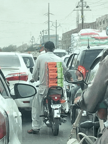 a man on a motorcycle is carrying boxes of gigabyte rtx rtx cards