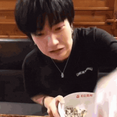 a person is holding a bowl of food with the word noodles on it