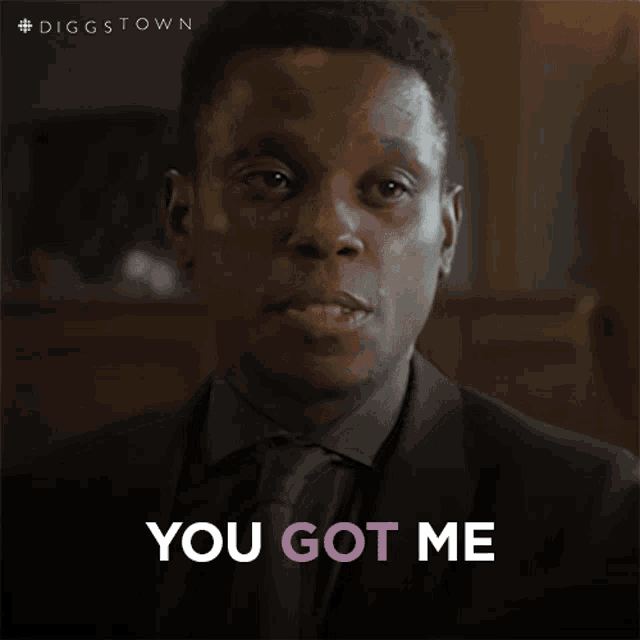 a man in a suit says you got me in pink letters