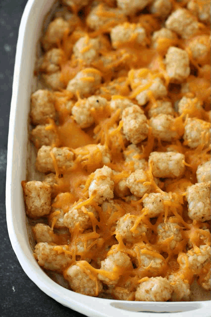 a casserole dish filled with chicken and cheese