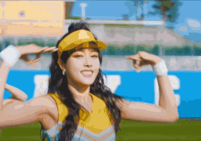 a pixelated image of a cheerleader wearing a yellow visor and smiling