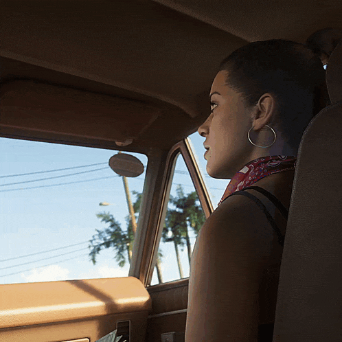 a woman wearing hoop earrings sits in a car