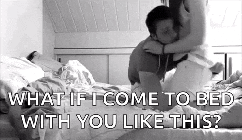 a man and a woman are kissing on a bed with the words `` what if i come to bed with you like this '' .