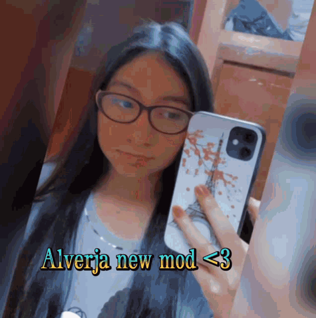 a girl taking a picture of herself with the words " alverja new mod < 3 " below her