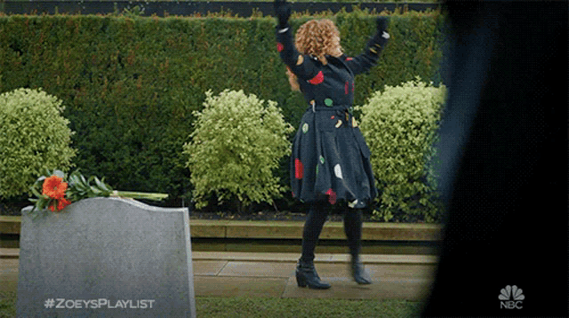 a woman is dancing in front of a grave with the hashtag #zoeysplaylist on it