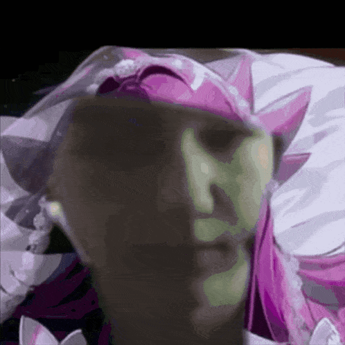 a close up of a person 's face with a pink hat