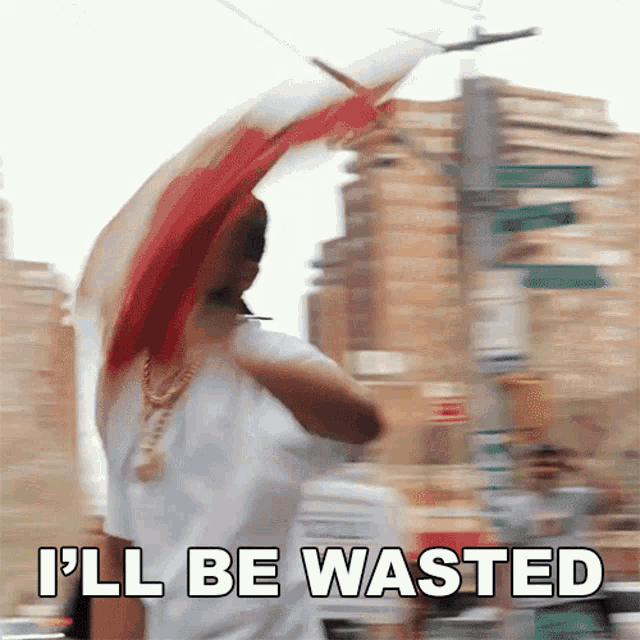 a blurry picture of a person holding a flag with the words " i 'll be wasted " on the bottom