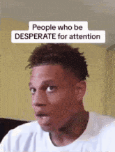 a man in a white shirt is making a funny face .