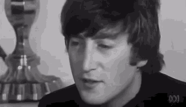a black and white photo of a man 's face .